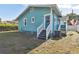 Back of teal house with stairs and AC unit at 111 W Ida St, Tampa, FL 33603