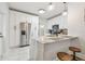 Modern kitchen with white cabinets, stainless steel appliances, and granite countertops at 111 W Ida St, Tampa, FL 33603