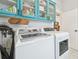 Laundry room with teal cabinets, washer, and dryer at 111 W Ida St, Tampa, FL 33603