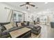 Bright living room with hardwood floors, sectional sofa, and ceiling fan at 111 W Ida St, Tampa, FL 33603