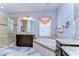 Bright bathroom featuring dual granite vanities, large soaking tub and tiled glass shower at 11308 Great Neck Rd, Riverview, FL 33578