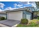 Two-car garage in a modern-style home with a well-maintained lawn and landscaping at 11308 Great Neck Rd, Riverview, FL 33578