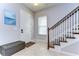 Welcoming foyer with tiled floors, staircase, and a bench at 11308 Great Neck Rd, Riverview, FL 33578