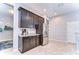 Bright kitchen area showcasing stainless steel refrigerator, granite counters, and tile flooring at 11308 Great Neck Rd, Riverview, FL 33578