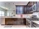 This kitchen features granite countertops, stainless steel appliances, and dark wood cabinetry at 11308 Great Neck Rd, Riverview, FL 33578