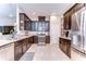 Spacious kitchen featuring granite countertops, stainless steel appliances, and dark wood cabinetry at 11308 Great Neck Rd, Riverview, FL 33578