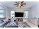 Comfortable living room featuring a ceiling fan, two windows, and a large sectional sofa at 11308 Great Neck Rd, Riverview, FL 33578