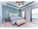 Relaxing main bedroom with tray ceiling, soft lighting, and neutral color palette at 11308 Great Neck Rd, Riverview, FL 33578