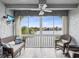 Relaxing balcony with wicker furniture and lake view at 11485 Oakhurst Dr # 1100-312, Largo, FL 33774