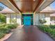 Recreation center entrance with teal doors and landscaping at 11485 Oakhurst Dr # 1100-312, Largo, FL 33774