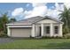 One-story home with gray roof and attached garage at 11827 Starbright Path, Venice, FL 34293