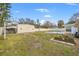 Backyard with pool, shed, and ample green space at 1243 Bayshore Dr, Terra Ceia, FL 34250