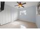 Bedroom with ceiling fan, tiled floors and ample closet space at 1243 Bayshore Dr, Terra Ceia, FL 34250