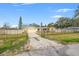 House with driveway and gate, offering curb appeal at 1243 Bayshore Dr, Terra Ceia, FL 34250