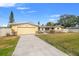 Front view of a yellow house with a stone facade at 1243 Bayshore Dr, Terra Ceia, FL 34250