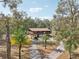 Aerial view of two-story home with surrounding trees at 13345 14Th St, Dade City, FL 33525