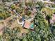 Aerial view of house, driveway, and surrounding trees at 13345 14Th St, Dade City, FL 33525