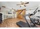 Home gym with a treadmill, exercise bike and wood flooring at 13345 14Th St, Dade City, FL 33525