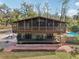 Back of house showing screened porch and garden at 13345 14Th St, Dade City, FL 33525