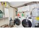 Functional laundry room with washer, dryer, and ample storage shelving at 13345 14Th St, Dade City, FL 33525