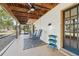 Screened porch with rocking chairs and a storage cart at 13345 14Th St, Dade City, FL 33525