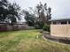 Large backyard with grassy area and wooden fence at 1373 Fairfax Rd, Clearwater, FL 33764