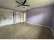 Spacious bedroom with ceiling fan and double doors at 1373 Fairfax Rd, Clearwater, FL 33764