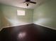 Simple bedroom with dark flooring and window at 1373 Fairfax Rd, Clearwater, FL 33764