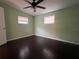 Bright bedroom with dark hardwood floors and ceiling fan at 1373 Fairfax Rd, Clearwater, FL 33764