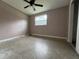 Simple bedroom with window and ceiling fan at 1373 Fairfax Rd, Clearwater, FL 33764