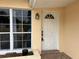 Light-colored front door with sidelights and a small porch at 1373 Fairfax Rd, Clearwater, FL 33764