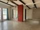 Living room with brick fireplace, mirrors, and large windows at 1373 Fairfax Rd, Clearwater, FL 33764