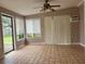 Bright sunroom with tile flooring and access to backyard at 1373 Fairfax Rd, Clearwater, FL 33764