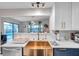 Modern kitchen with copper farmhouse sink and white quartz countertops at 1753 Lucas Dr, Clearwater, FL 33759