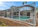 Relaxing kidney-shaped pool with screened enclosure at 1753 Lucas Dr, Clearwater, FL 33759