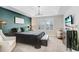 Main bedroom with a king-size bed, green accent wall, and TV at 17806 Althea Blue Pl, Lutz, FL 33558