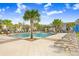 Resort-style pool with lounge chairs and palm trees at 17806 Althea Blue Pl, Lutz, FL 33558