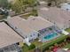 Aerial view of house, pool, and surrounding neighborhood at 19145 Cherry Rose Cir, Lutz, FL 33558