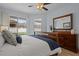 Main bedroom with pool view and large dresser at 19145 Cherry Rose Cir, Lutz, FL 33558