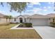 One-story home with attached garage, landscaping, and walkway at 19145 Cherry Rose Cir, Lutz, FL 33558