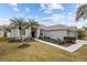 Well-maintained house with palm trees and a paved walkway at 19145 Cherry Rose Cir, Lutz, FL 33558