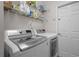 Laundry room with washer, dryer, and overhead storage at 19145 Cherry Rose Cir, Lutz, FL 33558