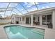 Relaxing kidney-shaped pool with screened enclosure and patio access at 19145 Cherry Rose Cir, Lutz, FL 33558