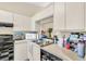 Galley kitchen with black appliances and checkered floor at 2188 Elm St # 1107, Dunedin, FL 34698