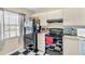 Galley kitchen with black appliances and checkered floor at 2188 Elm St # 1107, Dunedin, FL 34698