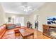 Bright living room featuring a leather couch, coffee table, and large TV at 2188 Elm St # 1107, Dunedin, FL 34698