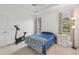 Bedroom with exercise bike and blue bedding at 2234 Preservation Green Ct, Sun City Center, FL 33573