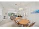 Bright dining room with wood table and view into living room at 2234 Preservation Green Ct, Sun City Center, FL 33573