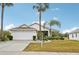 House exterior with landscaping and palm trees at 2234 Preservation Green Ct, Sun City Center, FL 33573