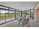 Bright sunroom with view and seating area at 2234 Preservation Green Ct, Sun City Center, FL 33573